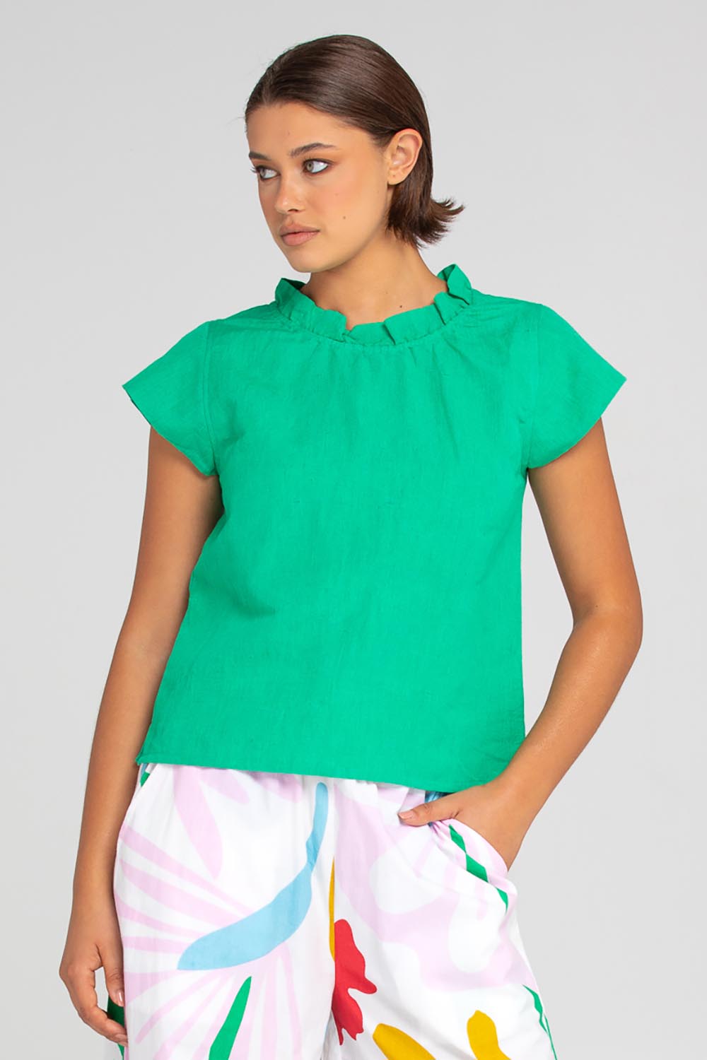 A model wearing the Sand Linen Cotton Top in colour Green (Green), from the front, cropped image