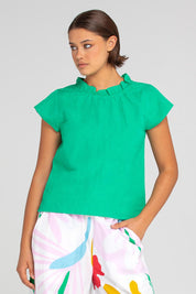 A model wearing the Sand Linen Cotton Top in colour Green (Green), from the front, cropped image