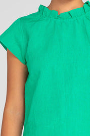 A model wearing the Sand Linen Cotton Top in colour Green (Green), from the front, cropped image