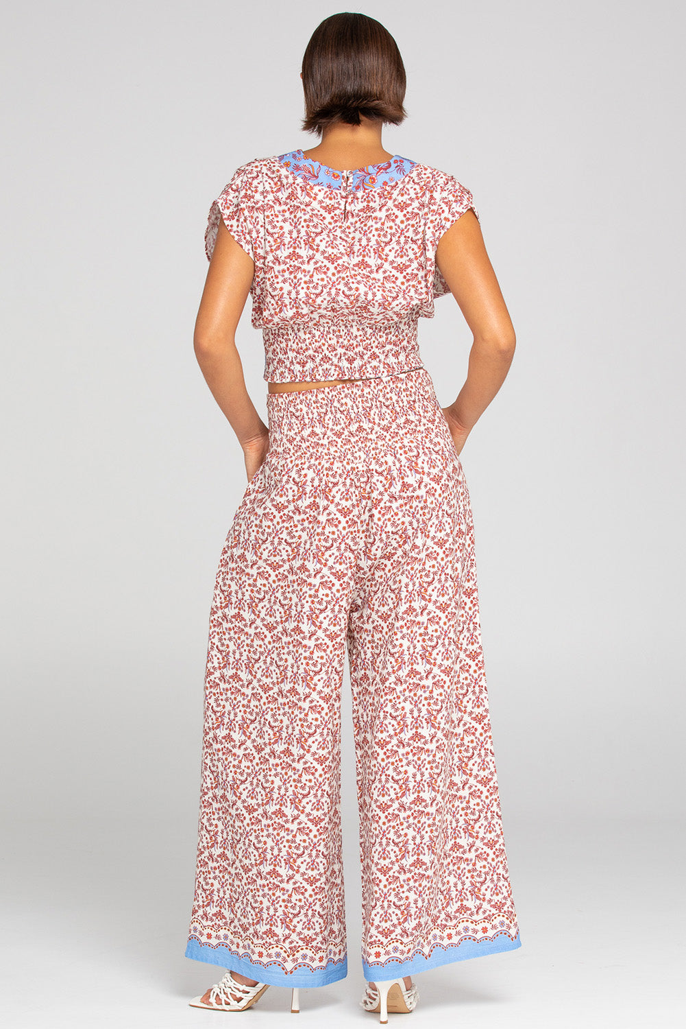 A model wearing the Desi Cotton Top in colour Paradise, from the back