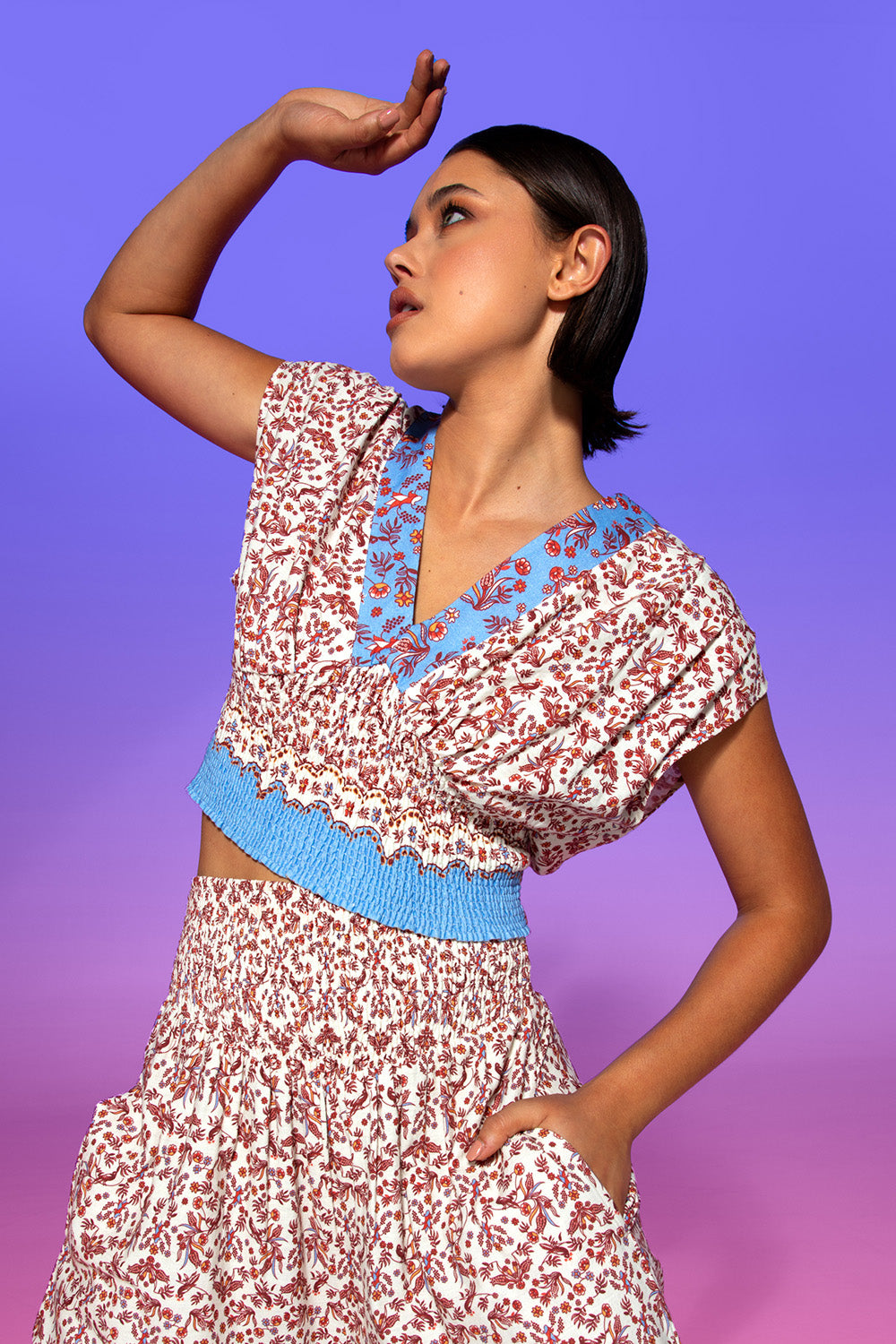 A model wearing the Desi Cotton Top in colour Paradise, from the front, showing the whole outfit