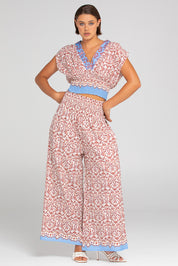 A model wearing the Desi Cotton Top in colour Paradise, from the front, showing the whole outfit
