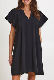 Model Madeline wearing size 10 of the Livy Cotton Dress in colour Black (Black), from the front, cropped image