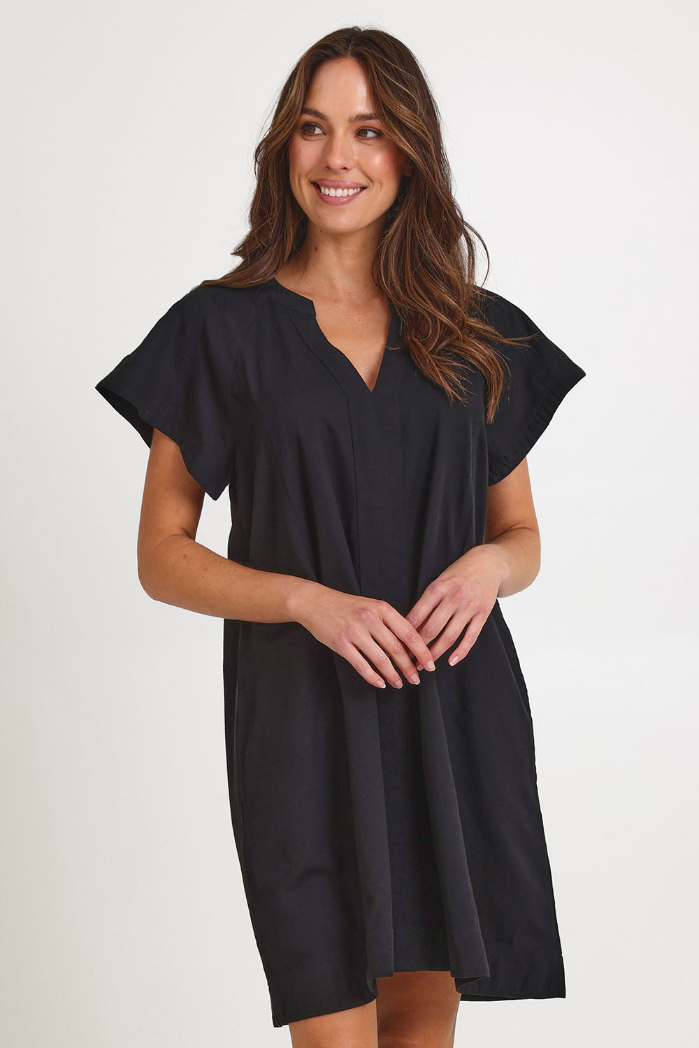 Model Madeline wearing size 10 of the Livy Cotton Dress in colour Black (Black), from the front, cropped image