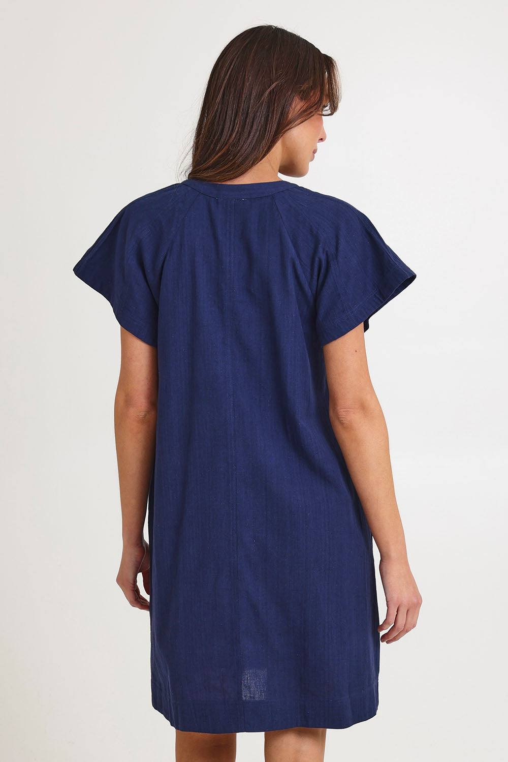 Model Madeline wearing size 10 of the Livy Cotton Dress in colour Navy (Blue), from the back
