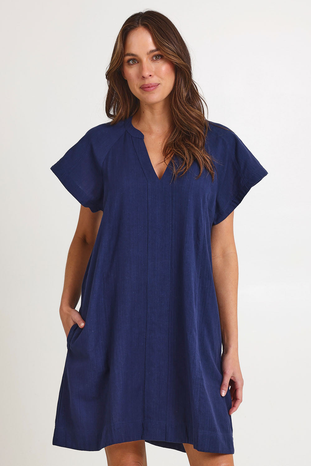 Model Madeline wearing size 10 of the Livy Cotton Dress in colour Navy (Blue), from the front, cropped image