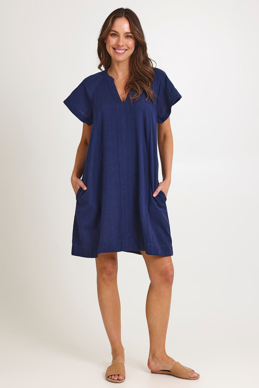 Model Madeline wearing size 10 of the Livy Cotton Dress in colour Navy (Blue), from the front, showing the whole outfit