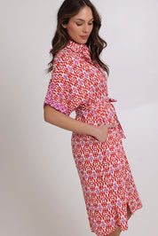Model Madeline wearing size 10 of the Maui Cotton Shirt Dress in colour Naples (Pink), from the front, cropped image