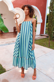 A model wearing the Sami Cotton Dress in colour Capriblue (Blue), from the front, showing the whole outfit