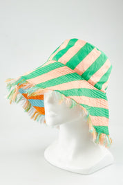 A model wearing the Fray Cotton Bucket Hat in colour Capripeach, from the front, showing the whole outfit