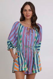 Model Madeline wearing size 10 of the Lucia Cotton Playsuit in colour Capris, from the front, cropped image