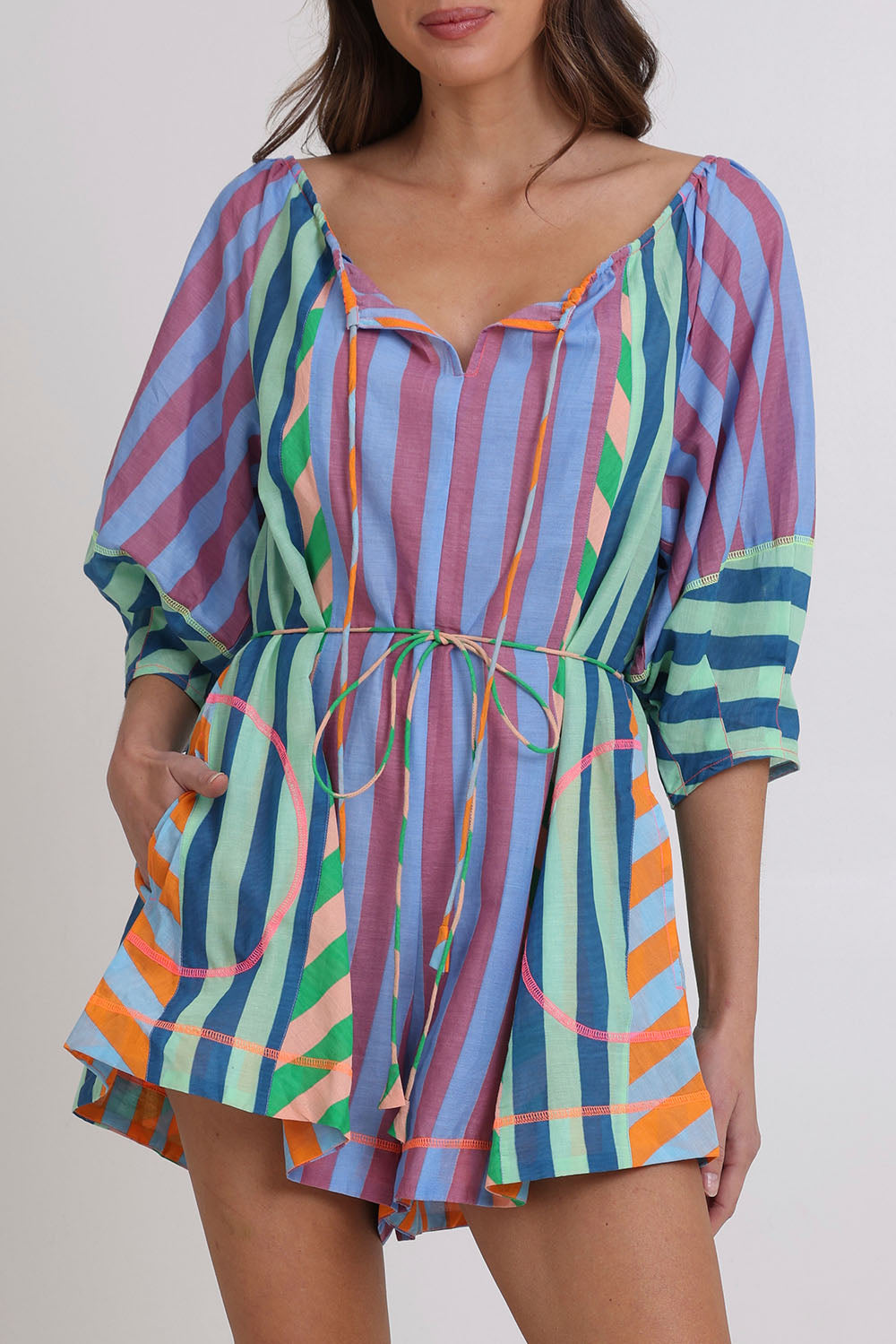 Model Madeline wearing size 10 of the Lucia Cotton Playsuit in colour Capris, from the front, cropped image