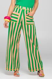 A model wearing the Sana Cotton Pant in colour Capri (Green), from the front, cropped image
