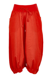 Product shot of the Guru Cotton Pant in colour Pomodoro (Red), from the front