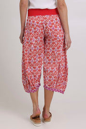 Model Madeline wearing size 10 of the Guru Cotton Pant in colour Naples (Pink), from the back