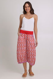 Model Madeline wearing size 10 of the Guru Cotton Pant in colour Naples (Pink), from the front, showing the whole outfit