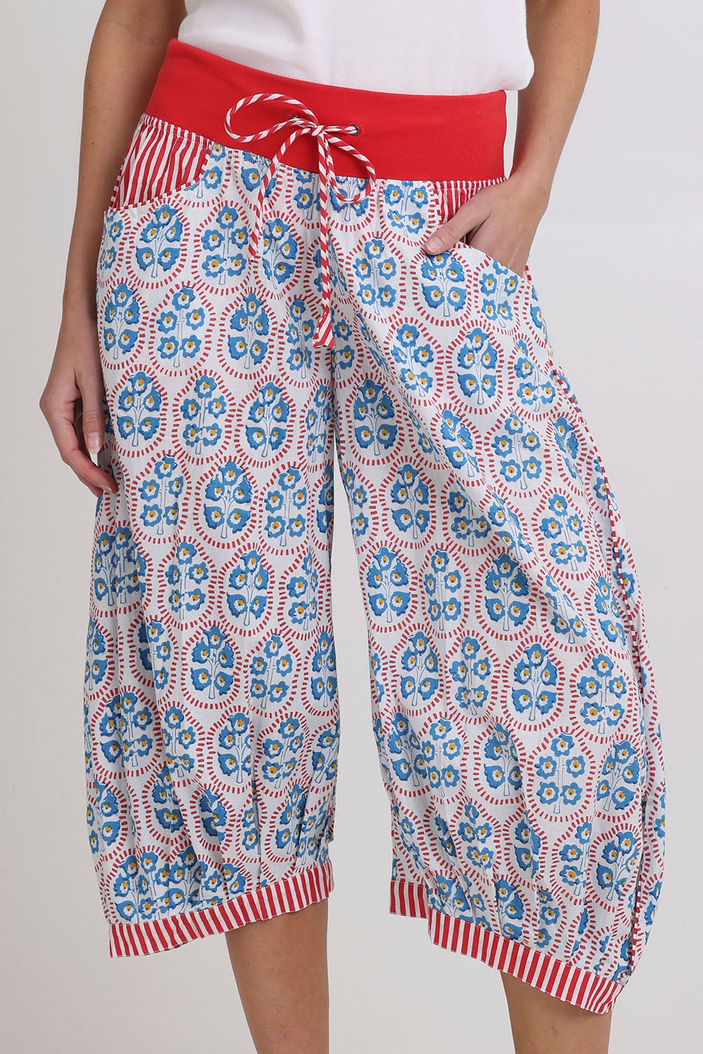 Model Madeline wearing size 10 of the Cuba Cotton Guru Pant in colour Emiliaw (Blue), from the front, cropped image