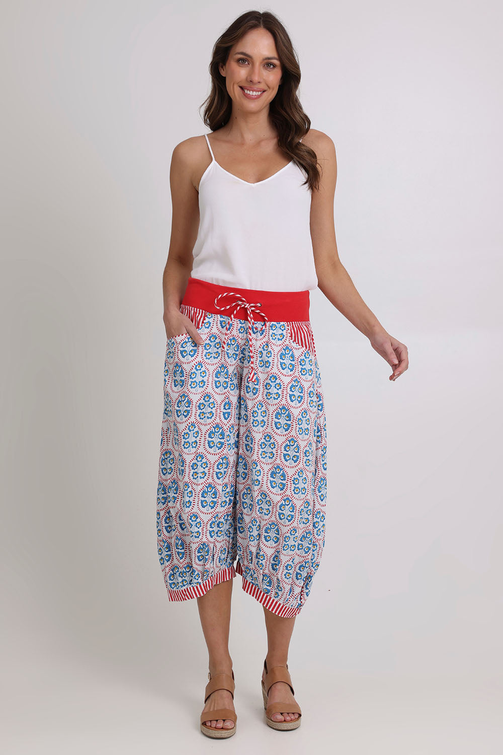 Model Madeline wearing size 10 of the Cuba Cotton Guru Pant in colour Emiliaw (Blue), from the front, showing the whole outfit