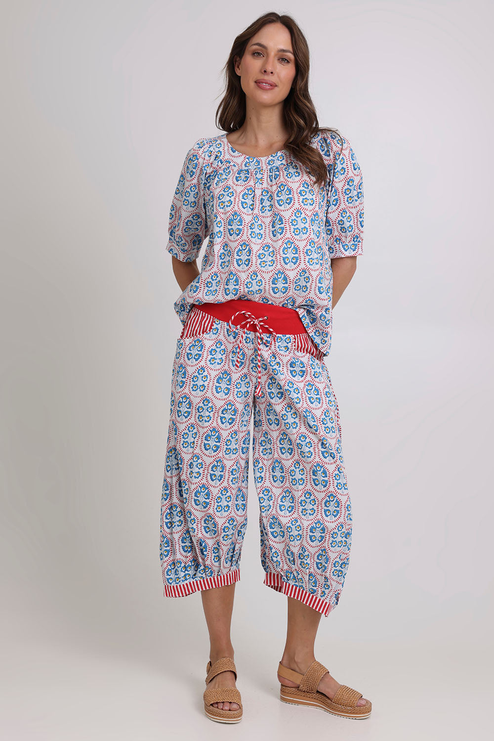 Model Madeline wearing size 10 of the Cuba Cotton Guru Pant in colour Emiliaw (Blue), from the front, showing the whole outfit