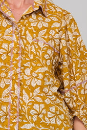 A model wearing the Pari Shirt in colour Mustard, from the front, cropped image