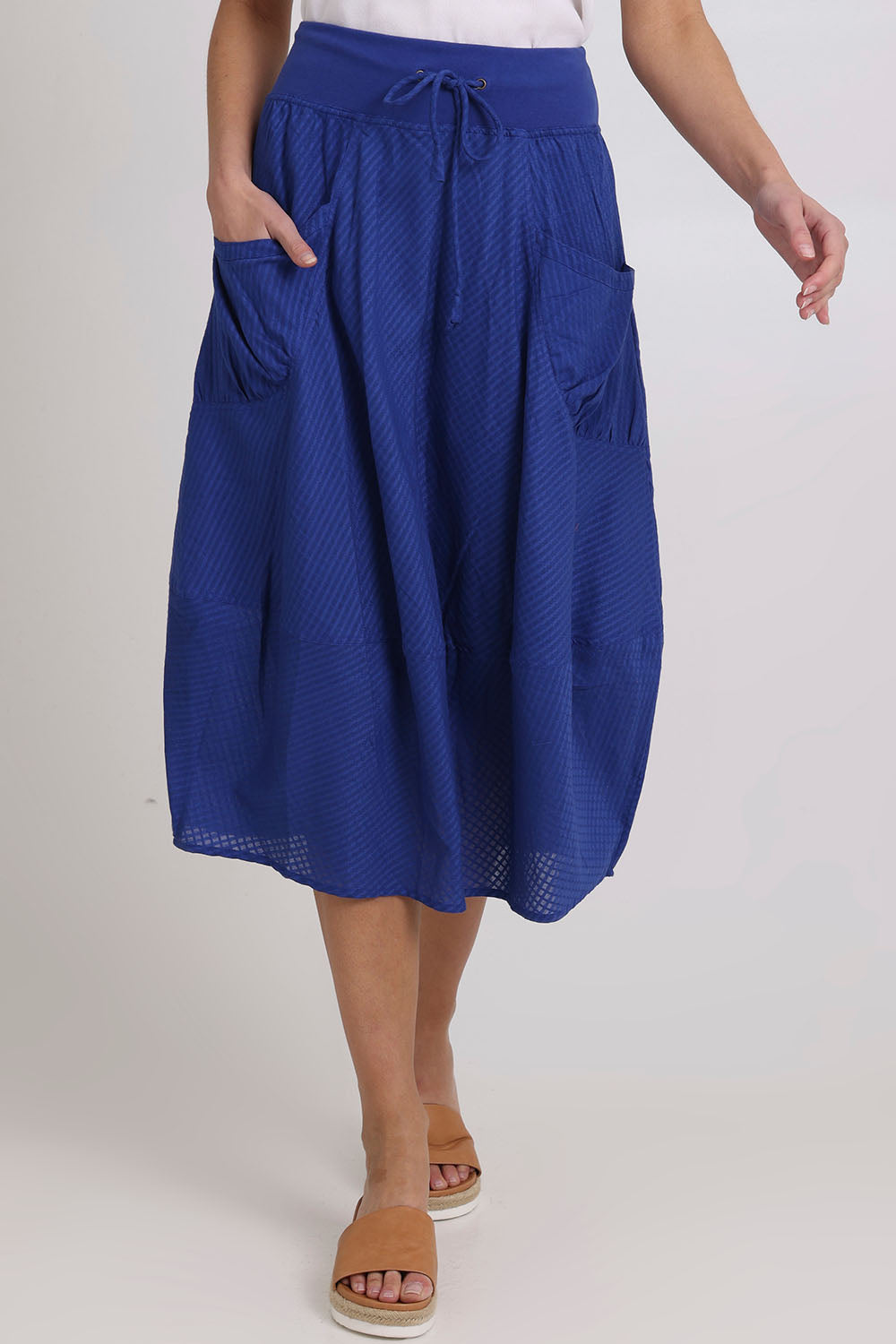 Model Madeline wearing size 10 of the Guru Cotton Skirt in colour Blu (Blue), from the front, showing the whole outfit