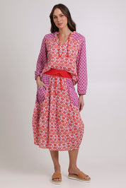 Model Madeline wearing size 10 of the Guru Cotton Skirt in colour Splicenap (Pink), from the front, showing the whole outfit