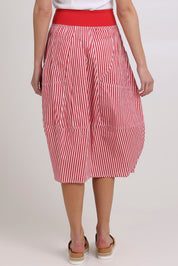 Model Madeline wearing size 10 of the Guru Cotton Skirt in colour Emilias (Red), from the back