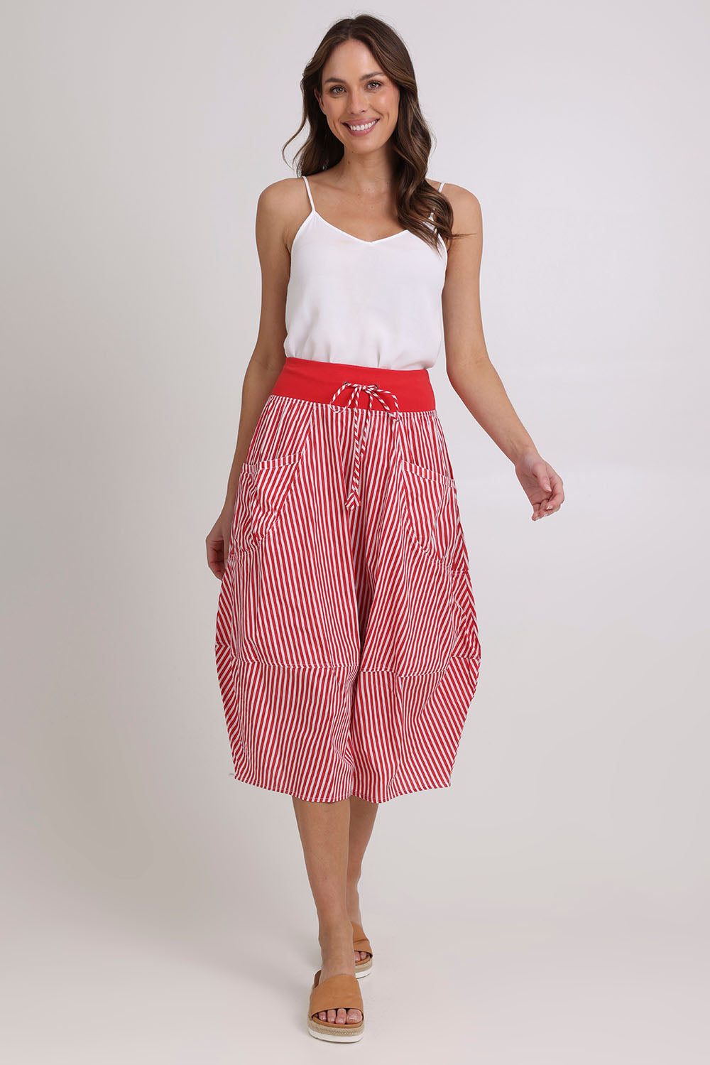 Model Madeline wearing size 10 of the Guru Cotton Skirt in colour Emilias (Red), from the front, showing the whole outfit