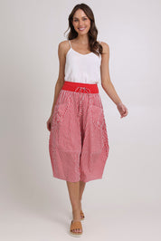 Model Madeline wearing size 10 of the Guru Cotton Skirt in colour Emilias (Red), from the front, showing the whole outfit