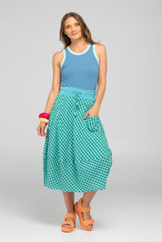 A model wearing the Guru Cotton Skirt in colour Green (Green), from the front, showing the whole outfit
