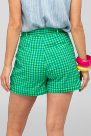 A model wearing the Hazel Cotton Short in colour Verde (Green), from the back