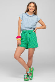 A model wearing the Hazel Cotton Short in colour Verde (Green), from the front, showing the whole outfit