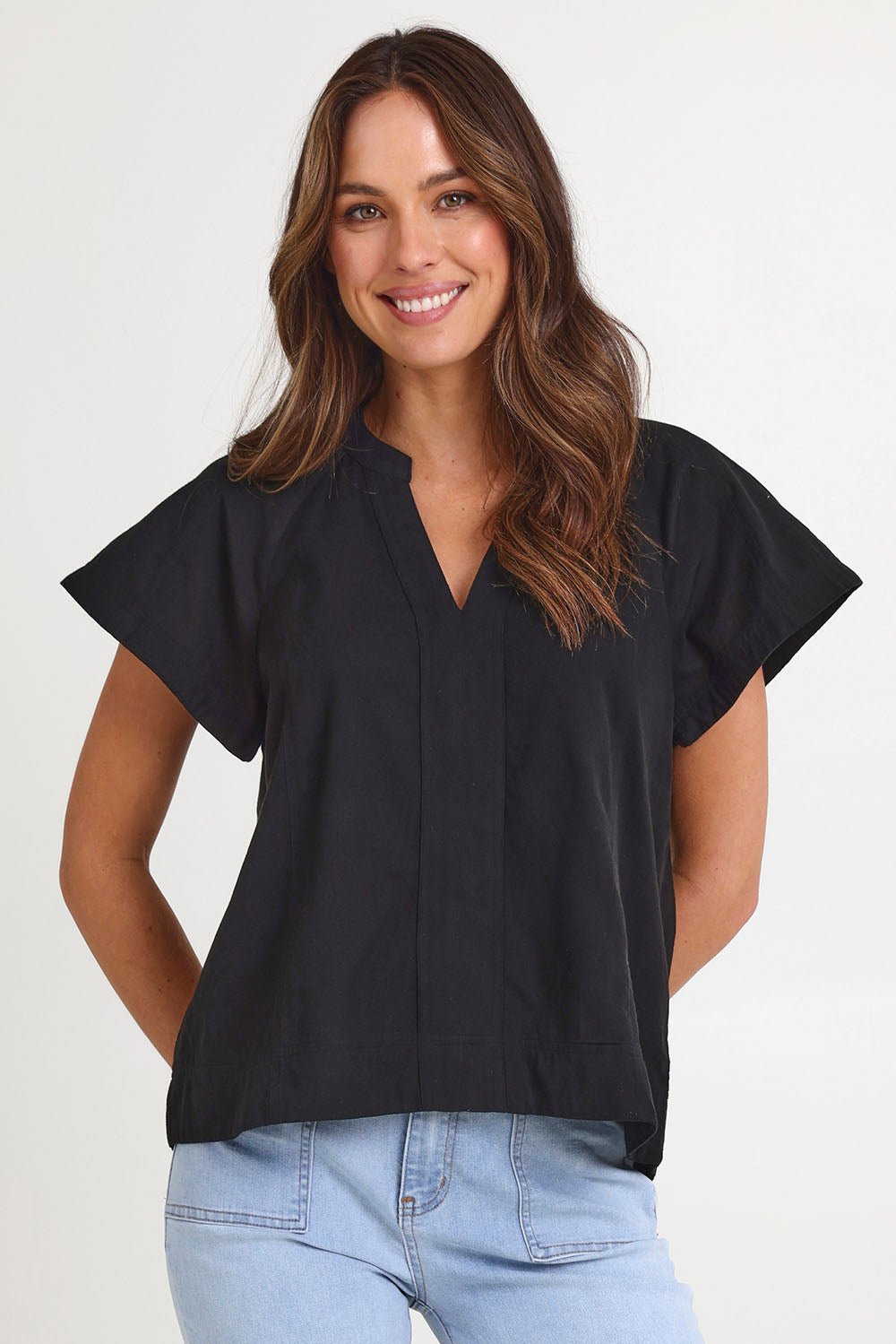 Model Madeline wearing size 10 of the Livy Cotton Top in colour Black (Black), from the front, cropped image