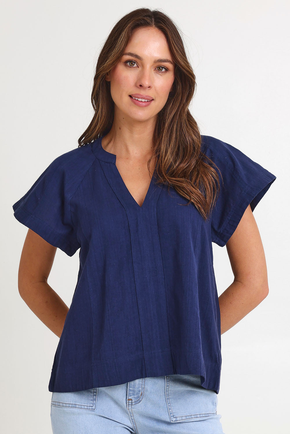 Model Madeline wearing size 10 of the Livy Cotton Top in colour Navy (Blue), from the front, cropped image
