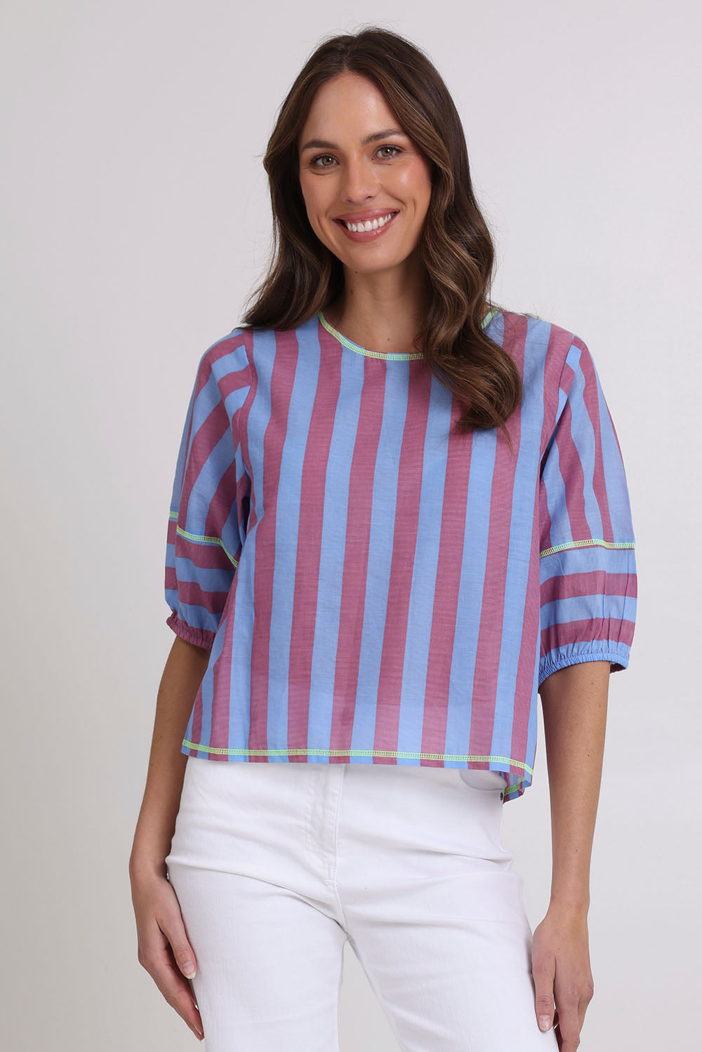 Model Madeline wearing size 10 of the Ava Cotton Top in colour Capriblue (Blue), from the front, cropped image
