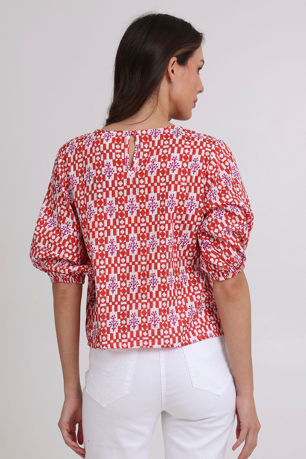 Model Madeline wearing size 10 of the Ava Cotton Top in colour Naples (Pink), from the back