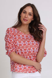 Model Madeline wearing size 10 of the Ava Cotton Top in colour Naples (Pink), from the front, cropped image