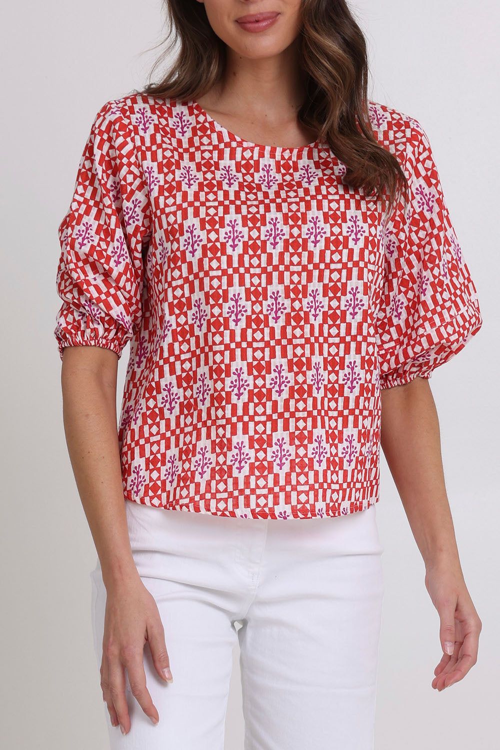 Model Madeline wearing size 10 of the Ava Cotton Top in colour Naples (Pink), from the front, cropped image