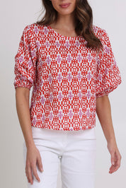 Model Madeline wearing size 10 of the Ava Cotton Top in colour Naples (Pink), from the front, cropped image