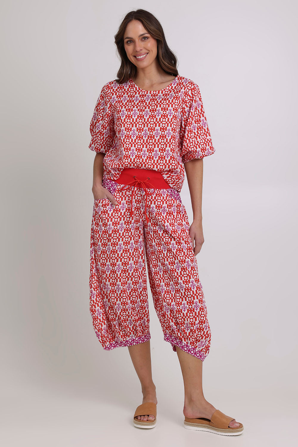 Model Madeline wearing size 10 of the Ava Cotton Top in colour Naples (Pink), from the front, showing the whole outfit