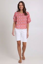 Model Madeline wearing size 10 of the Ava Cotton Top in colour Naples (Pink), from the front, showing the whole outfit