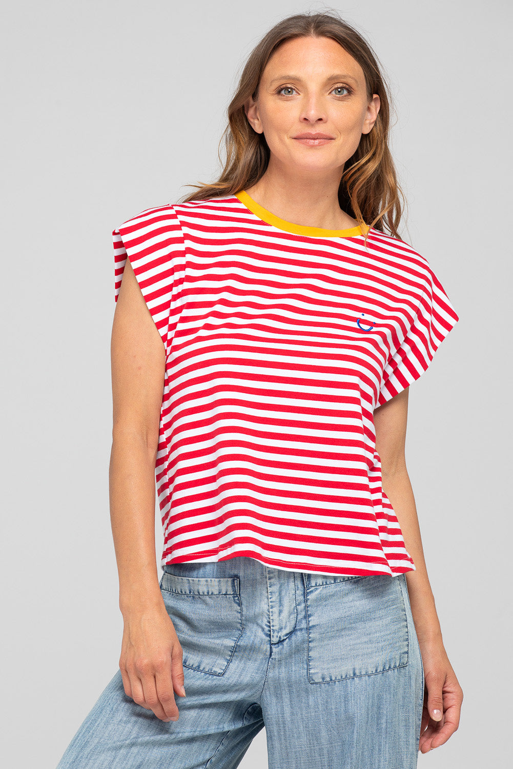 A model wearing the Bellissimo Cotton Tee in colour Redstripe (Red), from the front, cropped image