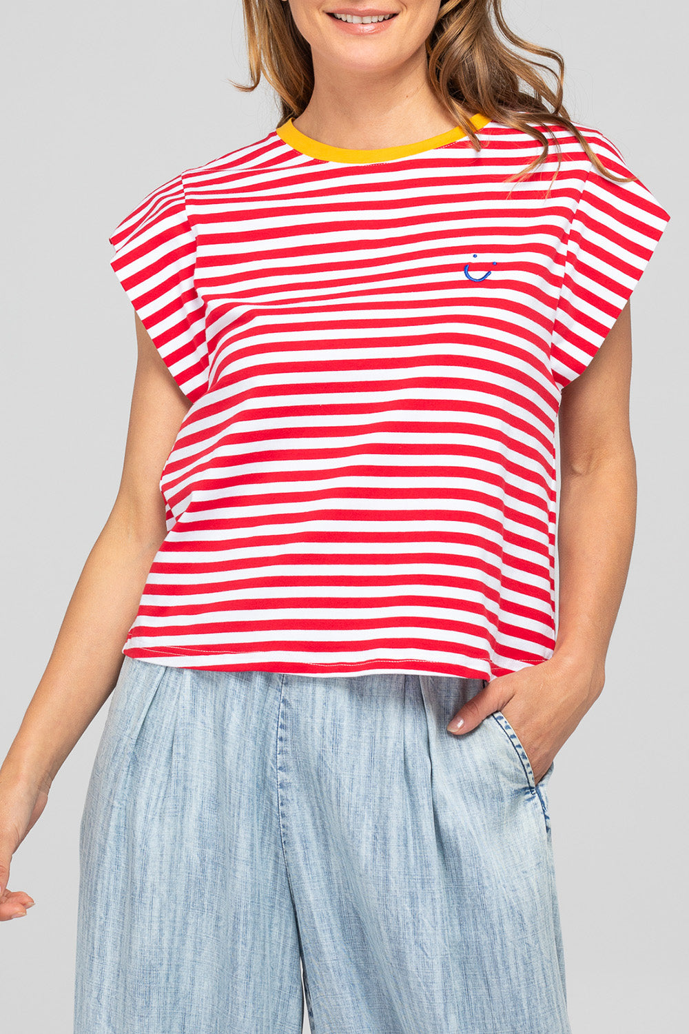 A model wearing the Bellissimo Cotton Tee in colour Redstripe (Red), from the front, cropped image
