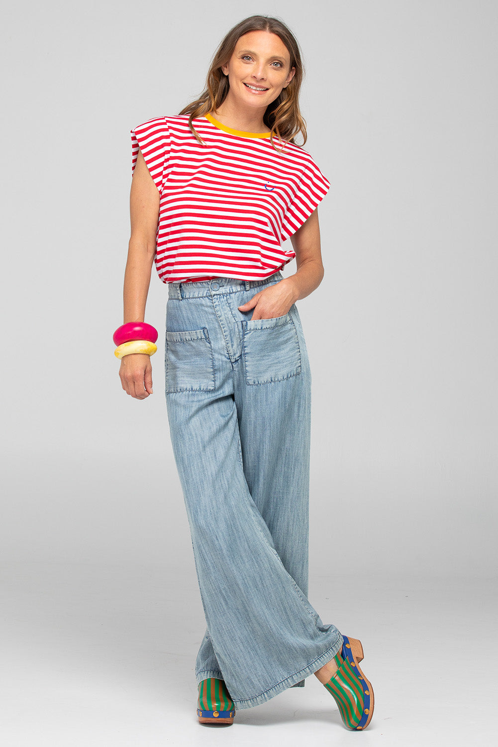 A model wearing the Bellissimo Cotton Tee in colour Redstripe (Red), from the front, showing the whole outfit