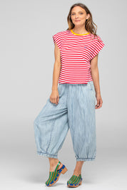A model wearing the Bellissimo Cotton Tee in colour Redstripe (Red), from the front, showing the whole outfit