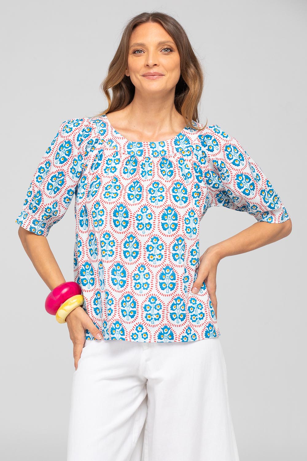 A model wearing the Bliss Cotton Top in colour Emiliaw (Blue), from the front, cropped image