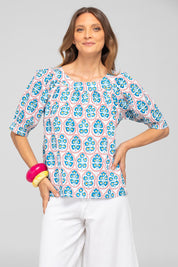 A model wearing the Bliss Cotton Top in colour Emiliaw (Blue), from the front, cropped image