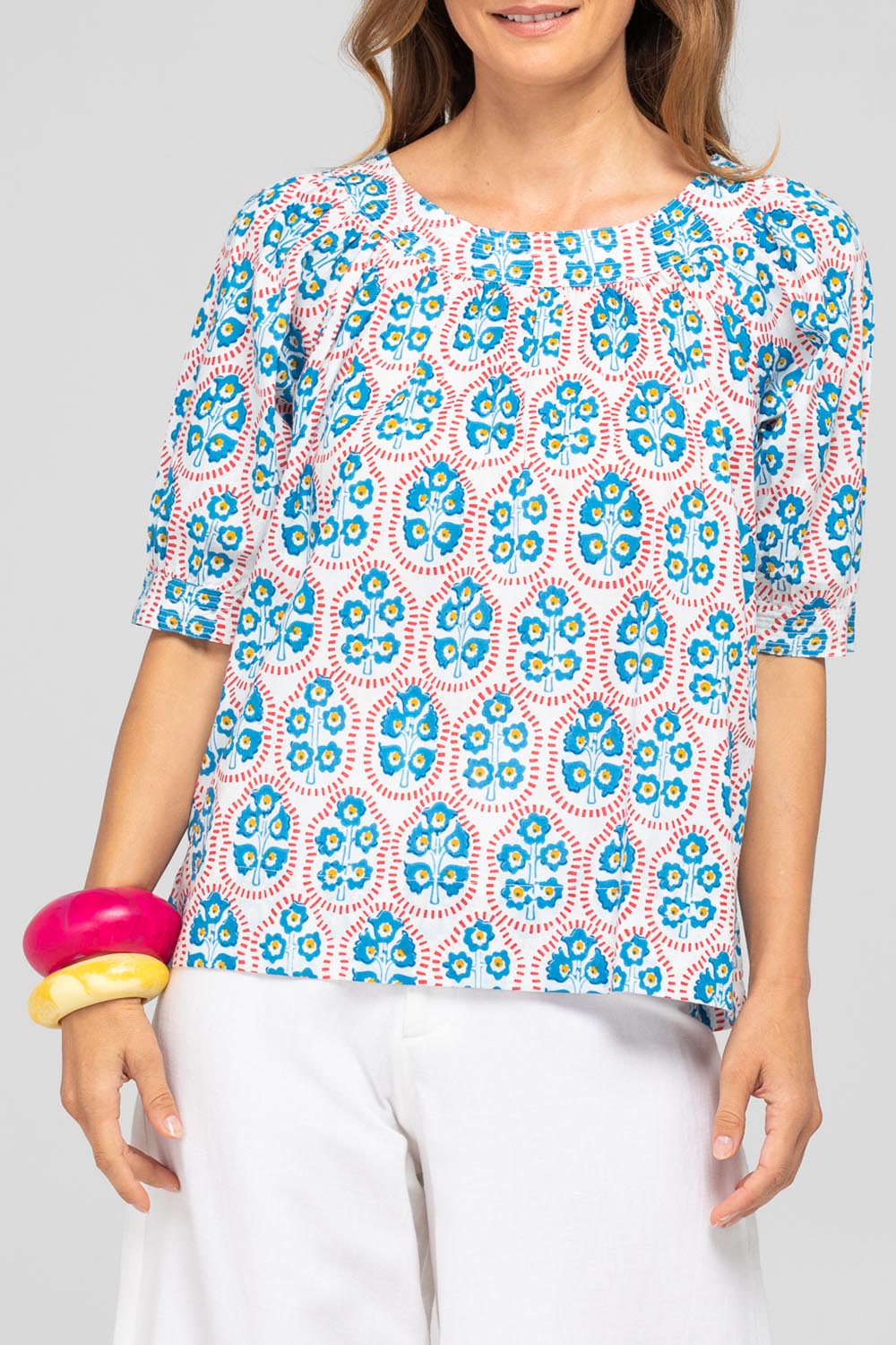 A model wearing the Bliss Cotton Top in colour Emiliaw (Blue), from the front, cropped image