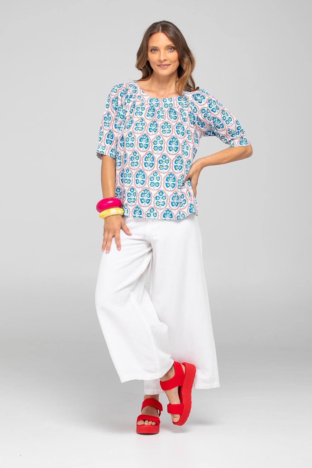 A model wearing the Bliss Cotton Top in colour Emiliaw (Blue), from the front, showing the whole outfit