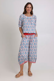 Model Madeline wearing size 10 of the Bliss Cotton Top in colour Emiliaw (Blue), from the front, showing the whole outfit